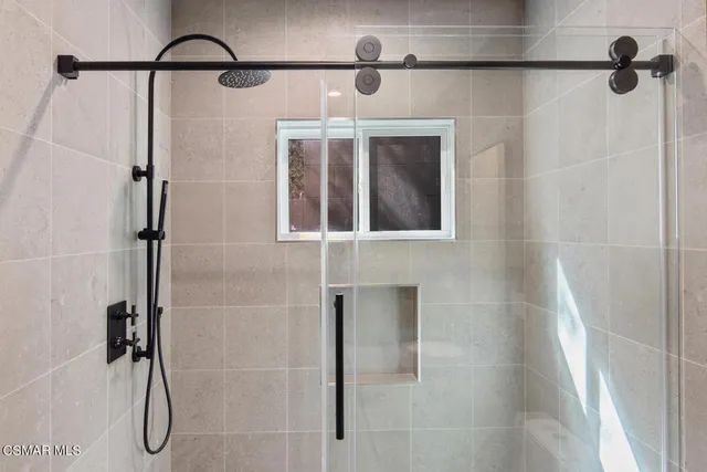 a bathroom with a shower and a shower head