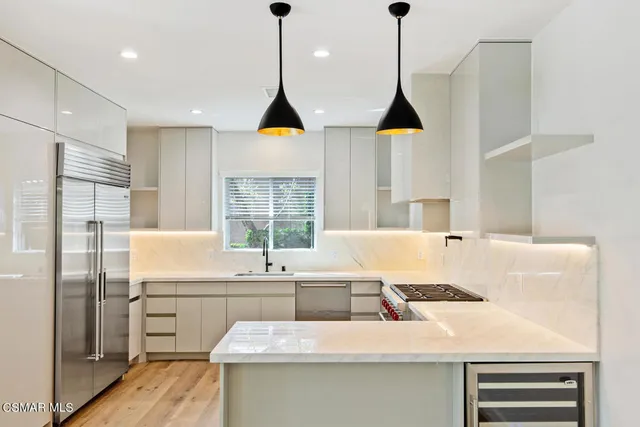 a kitchen with a sink a window and cabinets