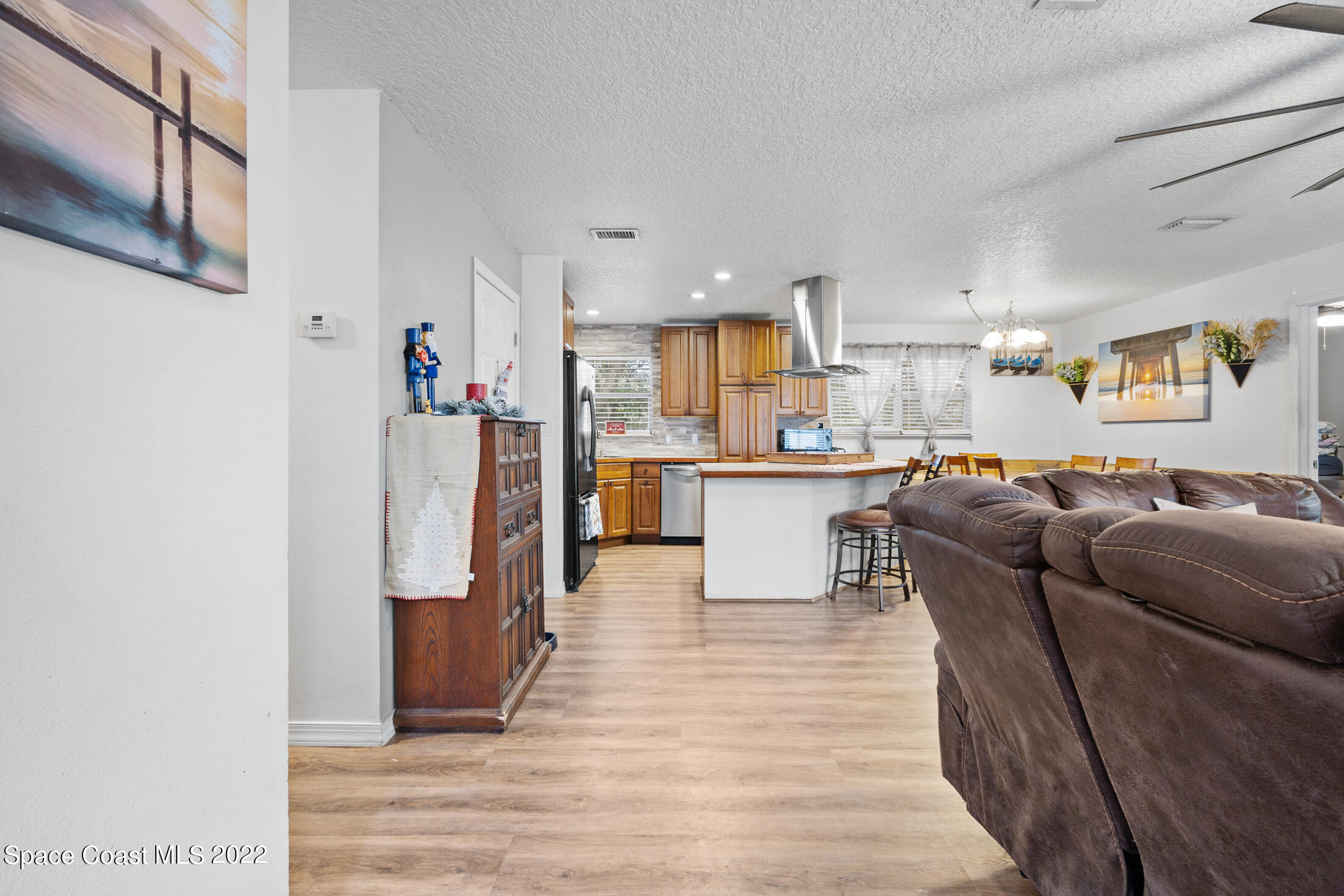 5480 Citrus Boulevard Cocoa, FL 32926 - Photo 18 of 43 a living room with kitchen island furniture and a kitchen view
