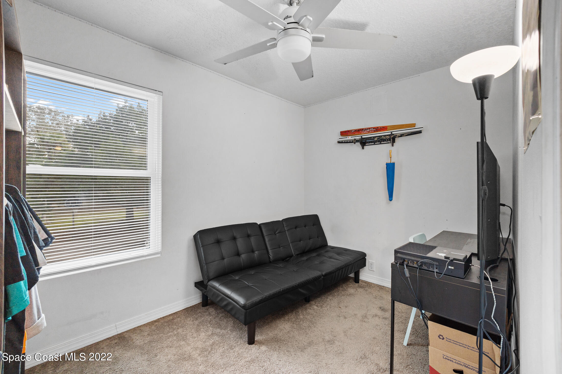 5480 Citrus Boulevard Cocoa, FL 32926 - Photo 28 of 43 a living room with furniture a ceiling fan and a window