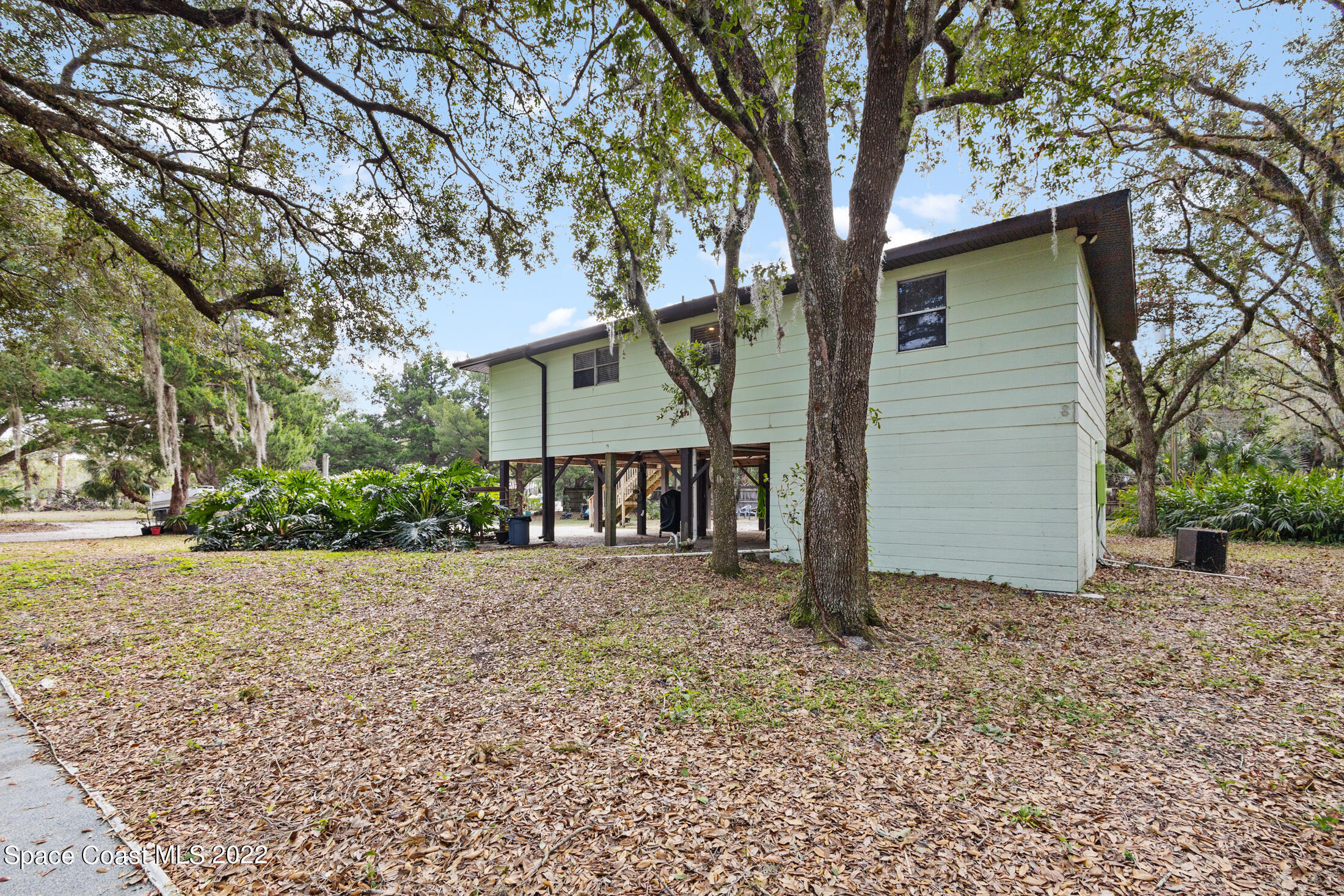 5480 Citrus Boulevard Cocoa, FL 32926 - Photo 34 of 43 front view of a house with a trees