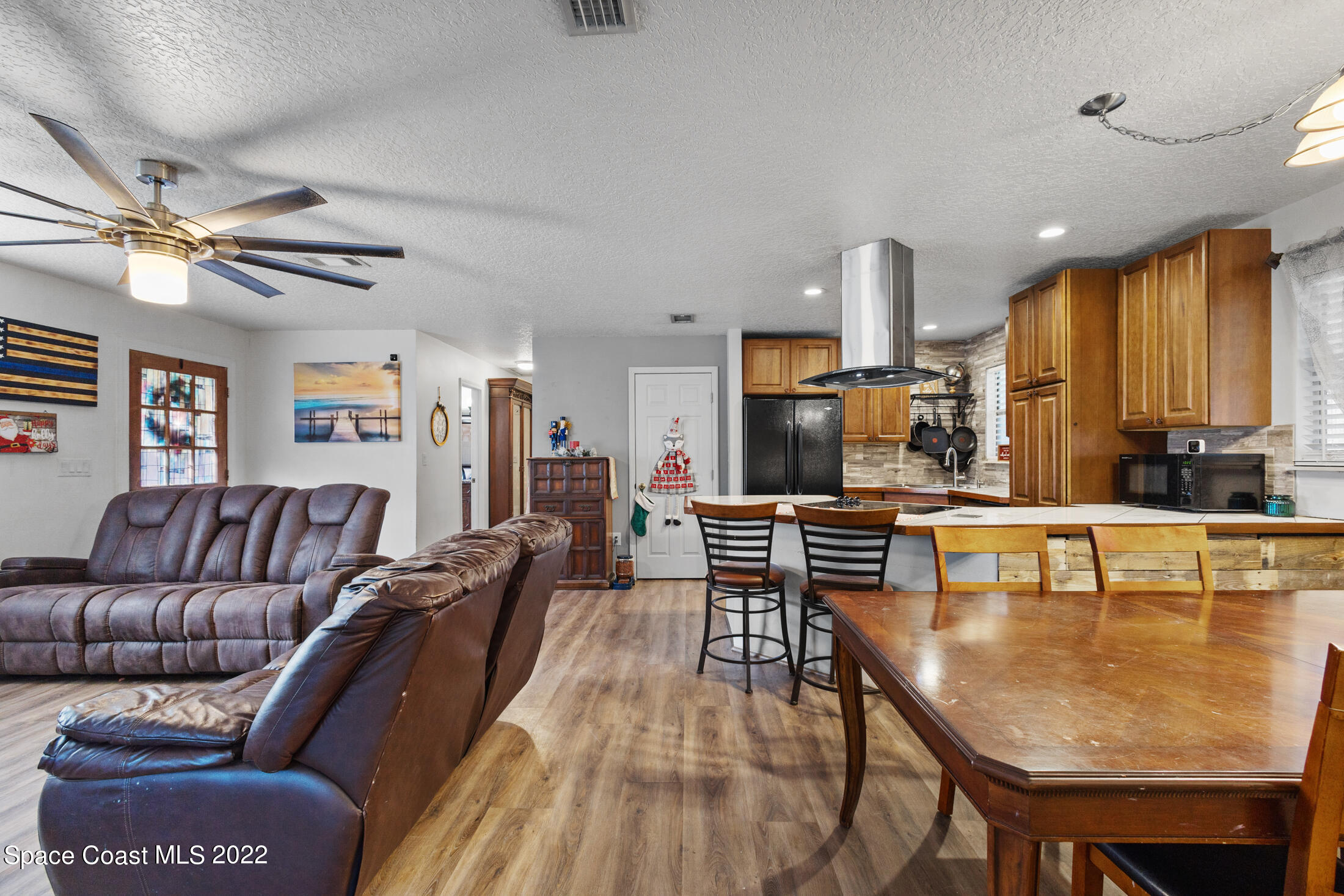 5480 Citrus Boulevard Cocoa, FL 32926 - Photo 10 of 43 a living room with stainless steel appliances furniture a dining table and kitchen view