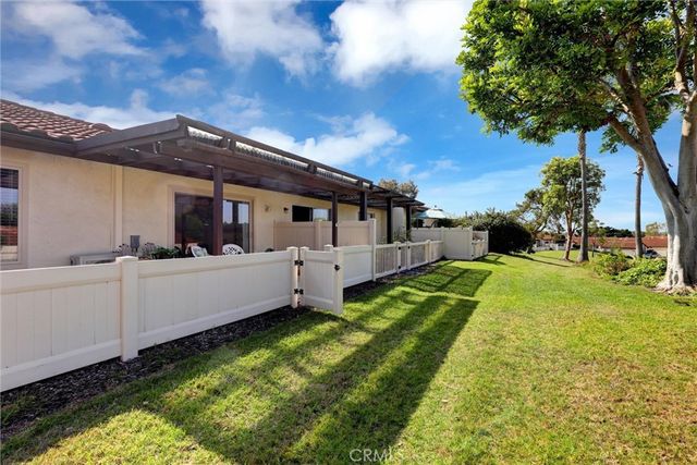 a kitchen with stainless steel appliances white cabinets a sink and a window