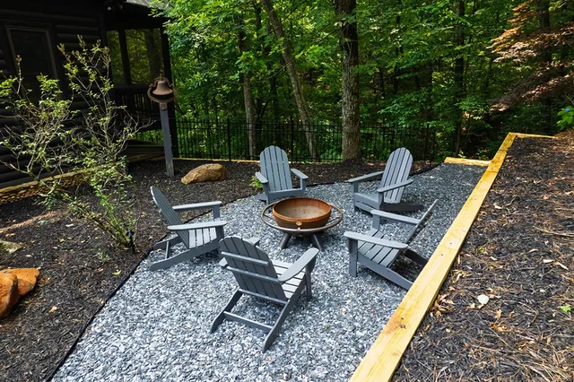 a living room with furniture fireplace and a large window