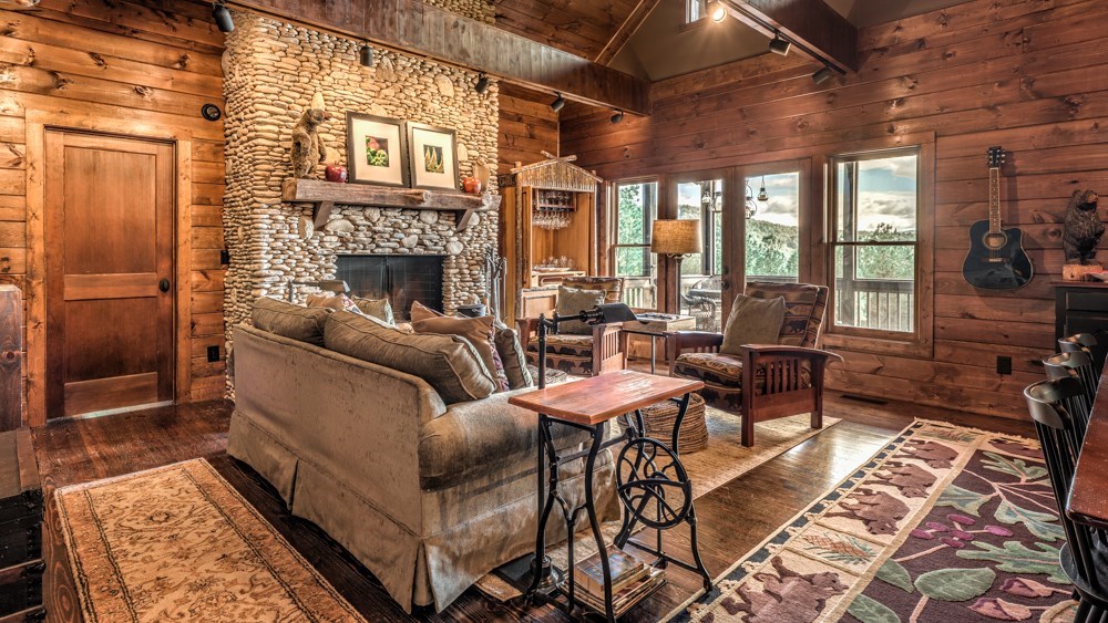 239 Ridge Top Drive Ellijay, GA 30536 - Photo 31 of 92 a living room with furniture a fireplace and a table