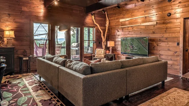 a living room with furniture and a chandelier