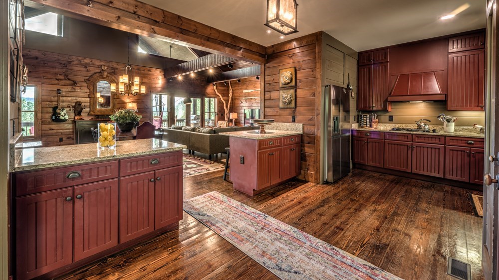 239 Ridge Top Drive Ellijay, GA 30536 - Photo 40 of 92 a kitchen with stainless steel appliances granite countertop sink stove and refrigerator