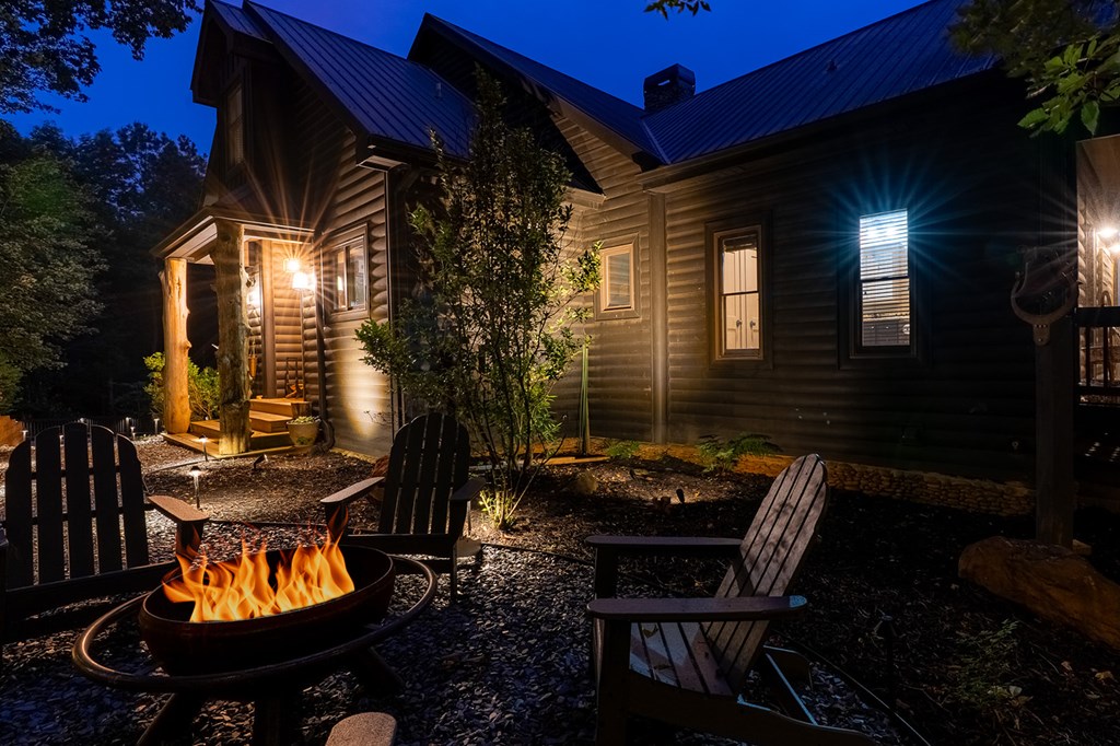 239 Ridge Top Drive Ellijay, GA 30536 - Photo 4 of 92 a backyard of a house with fire pit table and chairs