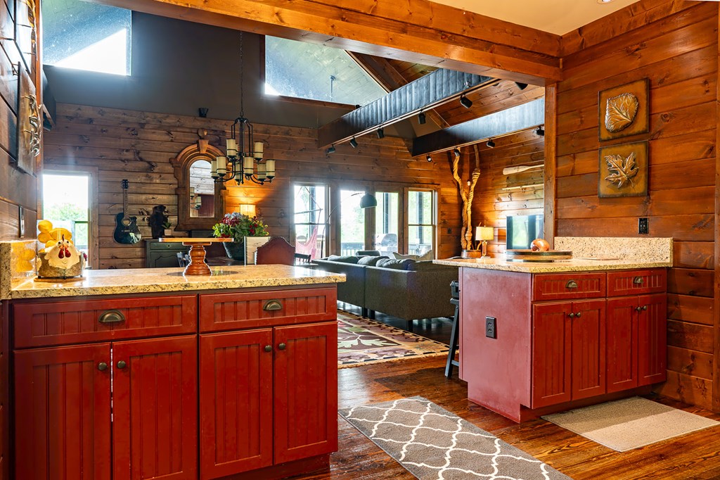 239 Ridge Top Drive Ellijay, GA 30536 - Photo 44 of 92 a kitchen with stainless steel appliances granite countertop a sink and wooden cabinets