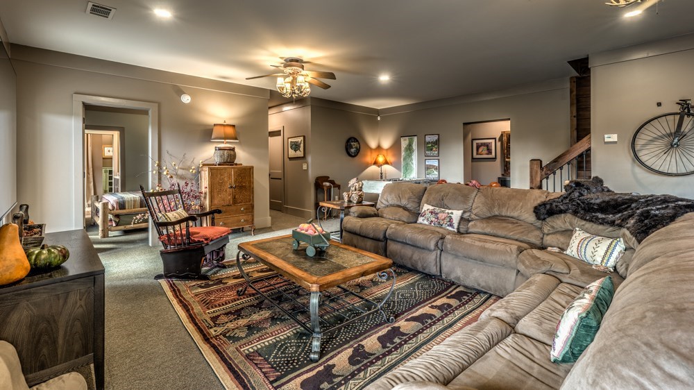 239 Ridge Top Drive Ellijay, GA 30536 - Photo 66 of 92 a living room with furniture and a chandelier