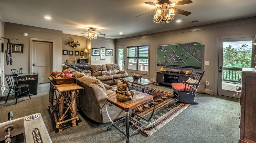 239 Ridge Top Drive Ellijay, GA 30536 - Photo 70 of 92 a living room with furniture a flat screen tv and a large window