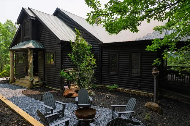 a backyard of a house with table and chairs