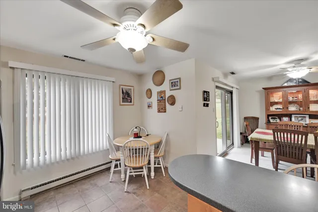 a dining room with furniture and window