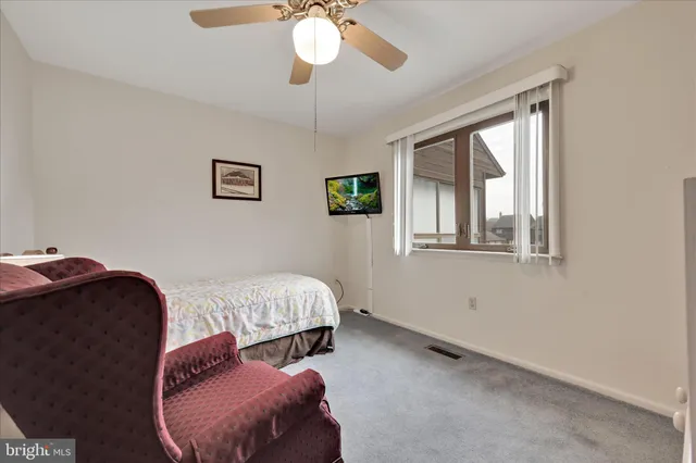 a spacious bedroom with a bed and window
