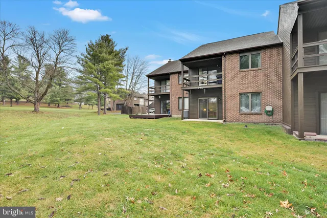 a large house with a big yard and large trees