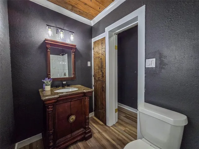 a bathroom with a toilet a sink and mirror
