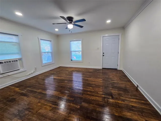 wooden floor in an empty room with a window