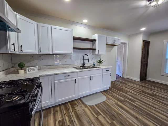 a kitchen with a sink stove and cabinets