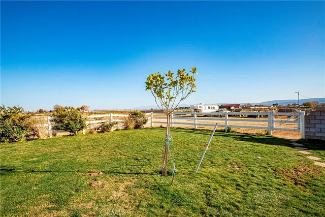 a big house with a big yard and large trees