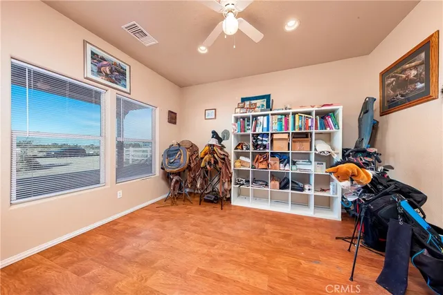 a view of an empty room with window and cabinet