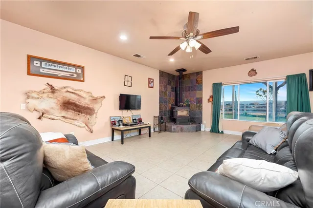 a kitchen with stainless steel appliances granite countertop a refrigerator a sink dishwasher a stove and white countertops with wooden floor