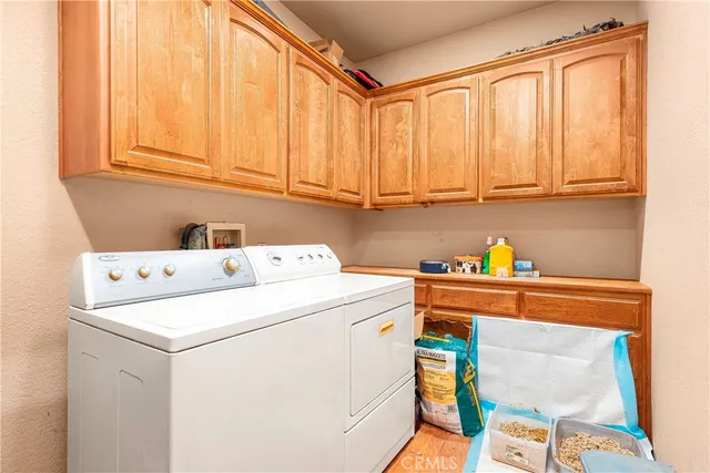 a bedroom with a bed a painting and a lamp