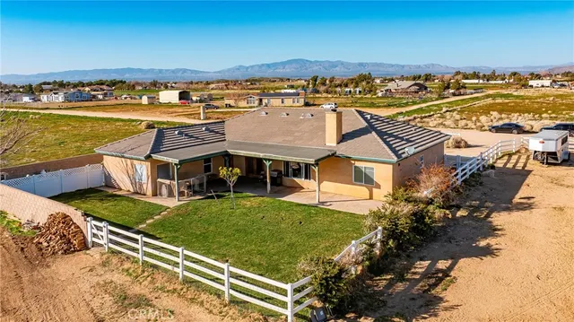an aerial view of residential houses with outdoor space and ocean view