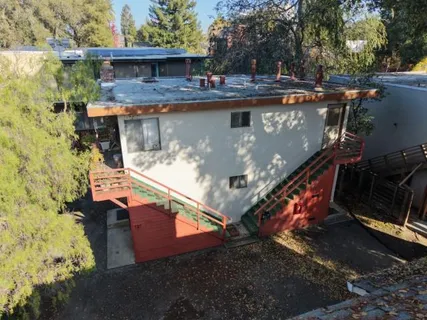 an aerial view of a house with a yard