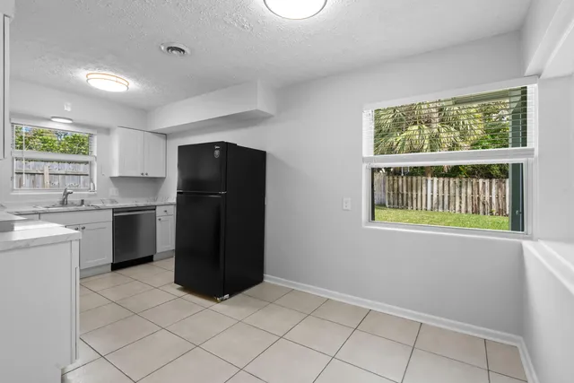 a kitchen with a refrigerator and window