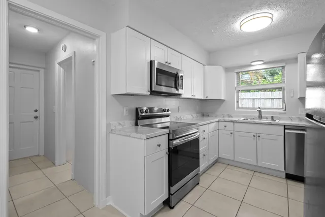 a kitchen with a stove top oven sink and cabinets