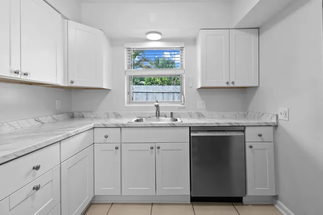 a kitchen with white cabinets and a sink