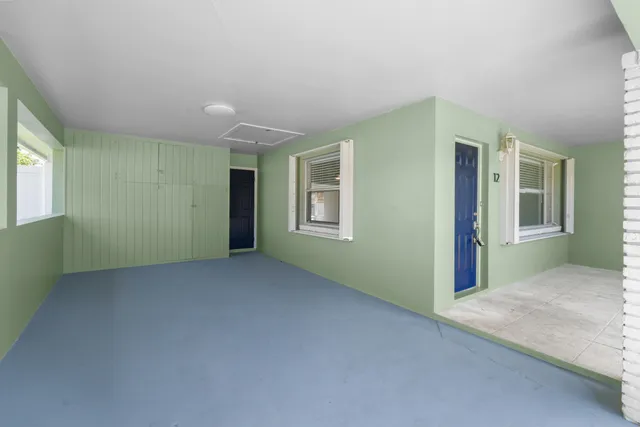 an empty room with windows and closet