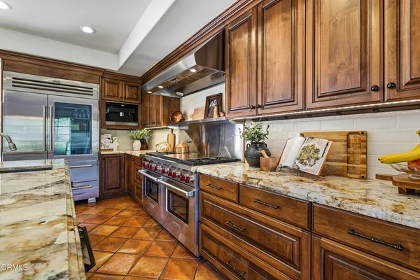 a utility room with granite countertop cabinets washer and dryer