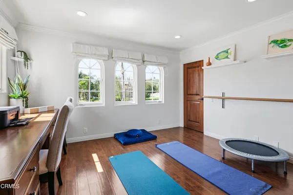 a view of a tennis ground with large trees