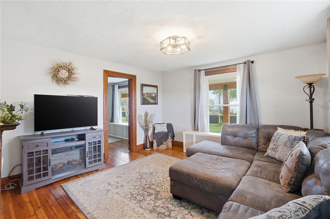 6155 North Union Road Clayton, OH 45315 - Photo 23 of 59 This inviting living area features warm wood flooring and a luminous ceiling light fixture.