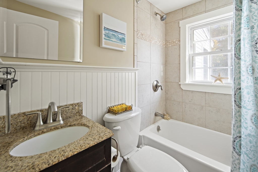 38 Sutcliffe Avenue Canton, MA 02021 - Photo 21 of 29 a bathroom with a granite countertop toilet a sink and a bathtub