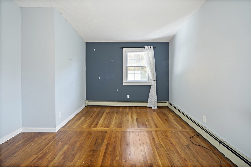 38 Sutcliffe Avenue Canton, MA 02021 - Photo 25 of 29 a view of an empty room with wooden floor and a window