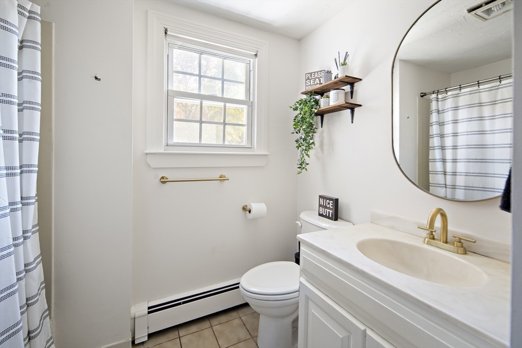 38 Sutcliffe Avenue Canton, MA 02021 - Photo 26 of 29 a bathroom with a sink toilet and a mirror