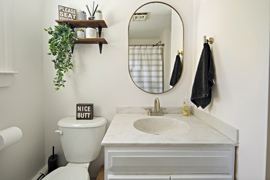 38 Sutcliffe Avenue Canton, MA 02021 - Photo 27 of 29 a bathroom with a toilet sink and mirror