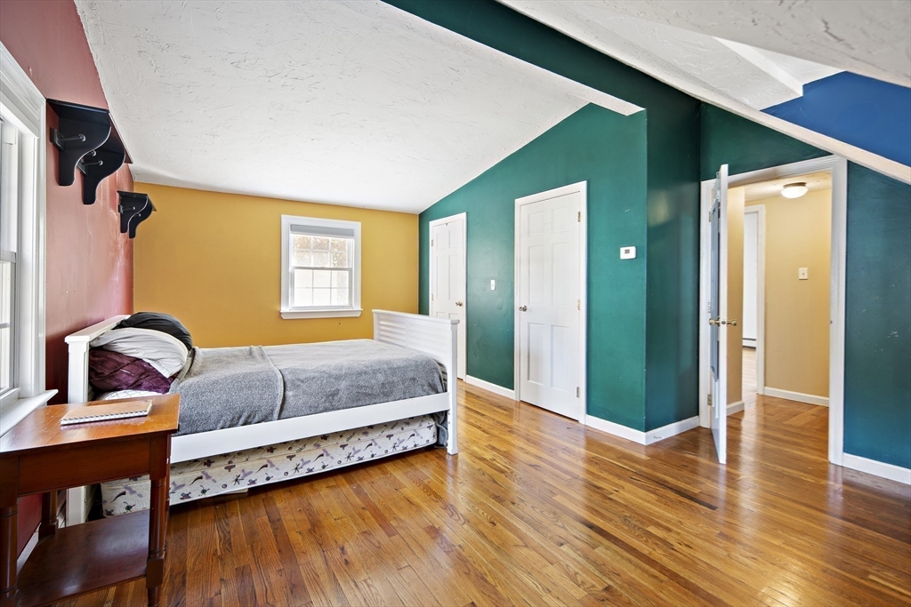 38 Sutcliffe Avenue Canton, MA 02021 - Photo 29 of 29 a bedroom with a bed and wooden floor