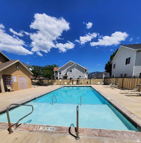 2525 West 450 South, Unit 8 Springville, UT 84663 - Photo 22 of 22 Rectangular swimming pool with metal handrails, surrounded by a concrete deck
