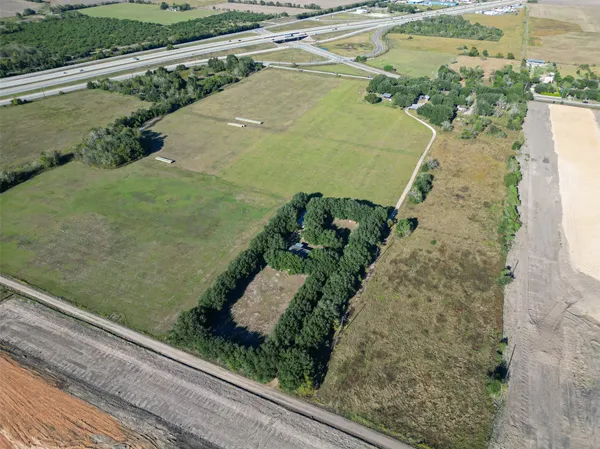 a view of a lake with a yard and large trees