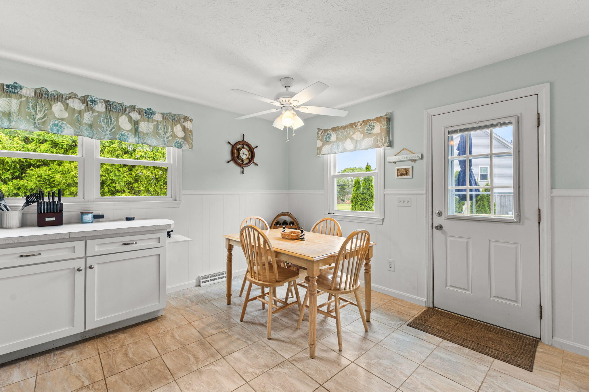 8 Stackpole Circle Bourne, MA 02532 - Photo 15 of 51 a kitchen with a dining table chairs and chandelier