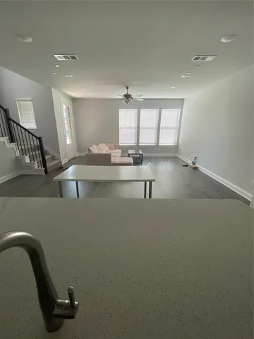 a view of a room with shelves and wooden floor