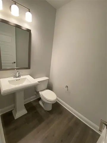 a bathroom with a sink and mirror with toilet