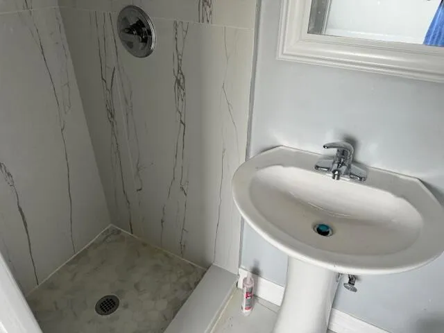 a view of a small space with wooden floor and a window