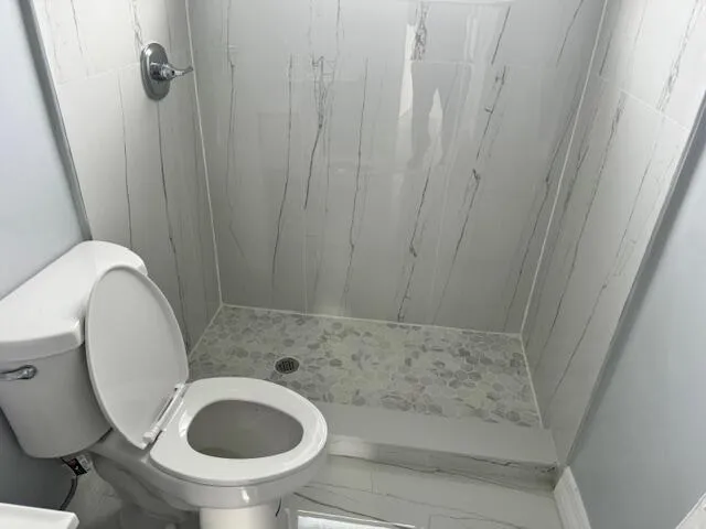 a view of empty room with wooden floor and window
