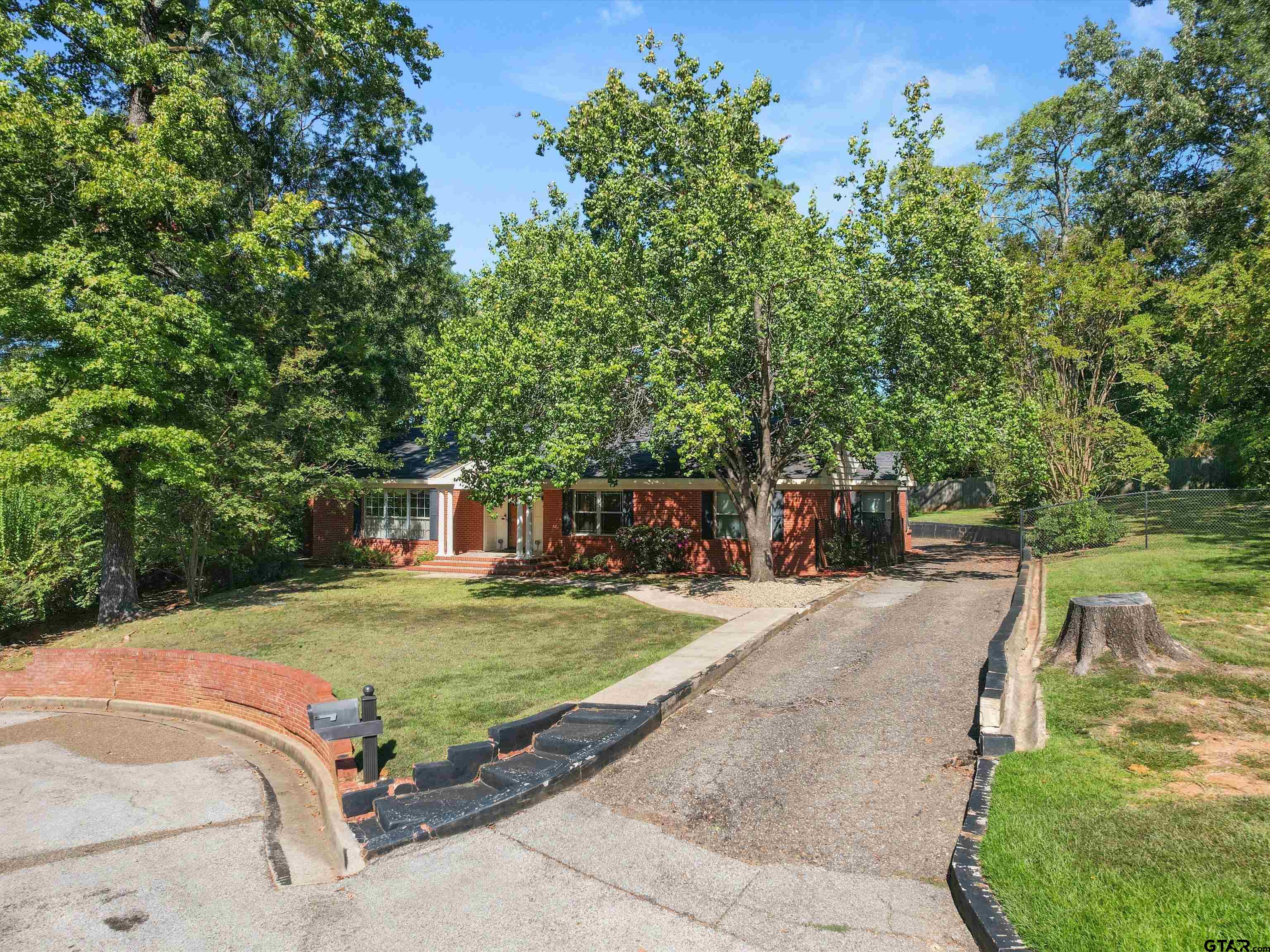 6 Lindsey Lane Longview, TX 75601 - Photo 1 of 33 a front view of a house with garden