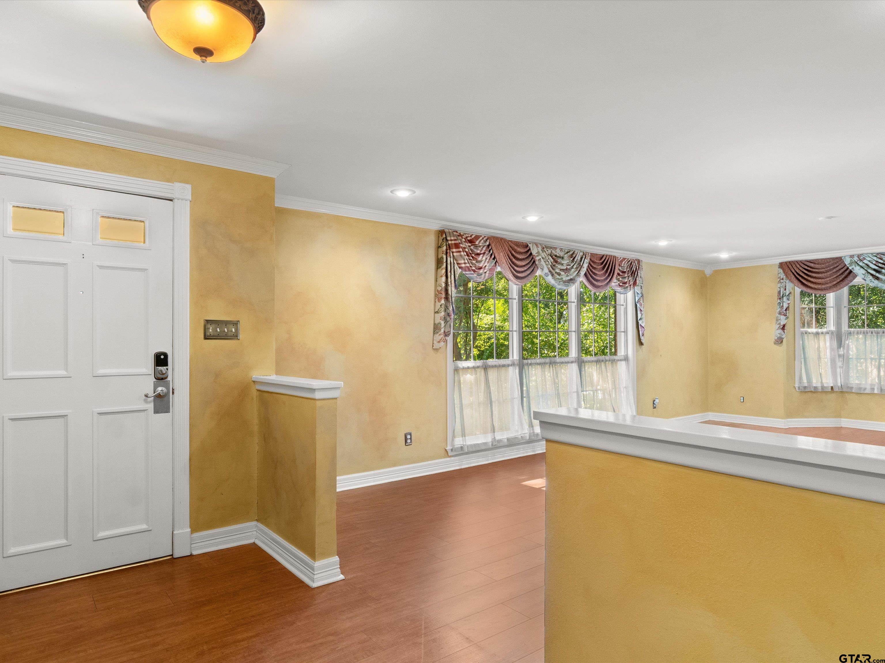 6 Lindsey Lane Longview, TX 75601 - Photo 11 of 33 an empty room with wooden floor and windows