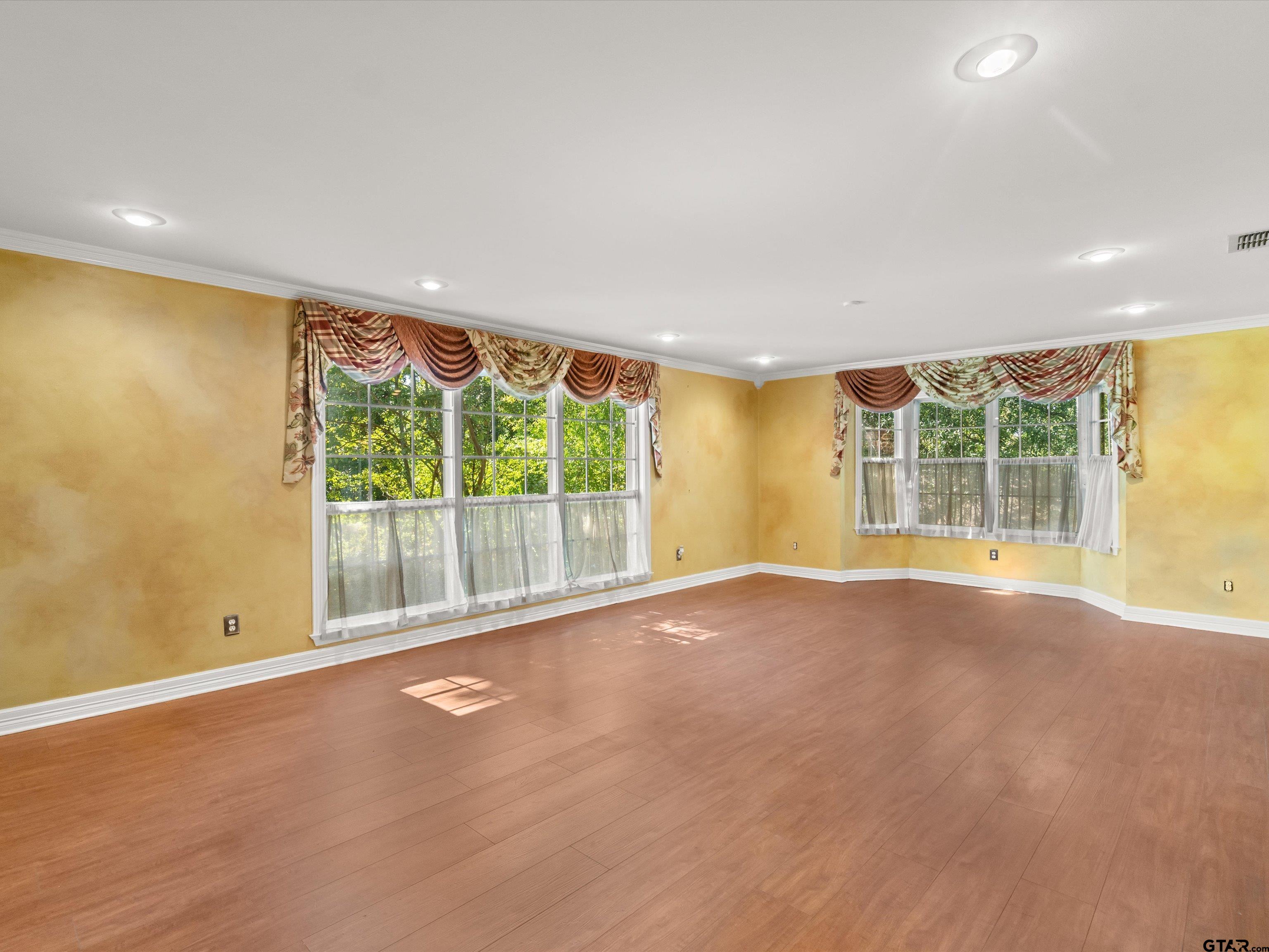 6 Lindsey Lane Longview, TX 75601 - Photo 12 of 33 a view of empty room with wooden floor and fan